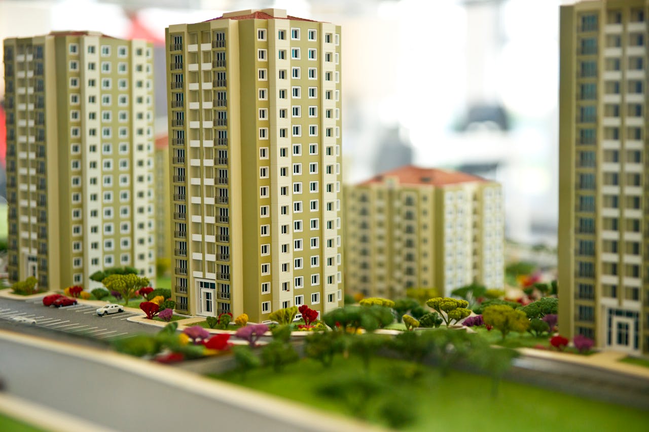 services-01 Close-up image of a modern residential building model, showcasing urban architecture.